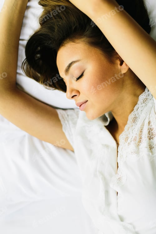 Preview: Above view of pretty woman in bed