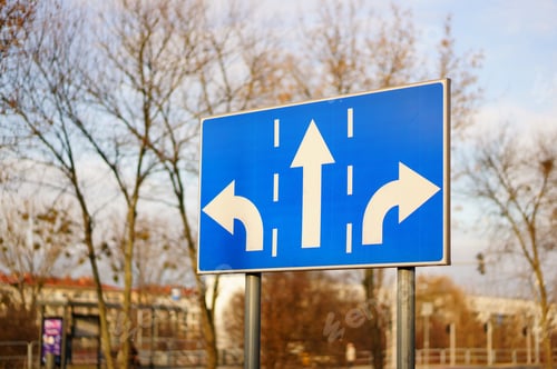 Preview: Threeway blue sign on the side of a road at daytime