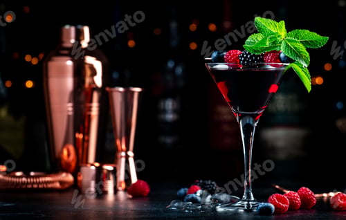 Preview: Summer alcoholic cocktail with berries, rum, juice, mint and ice, black background with bottles
