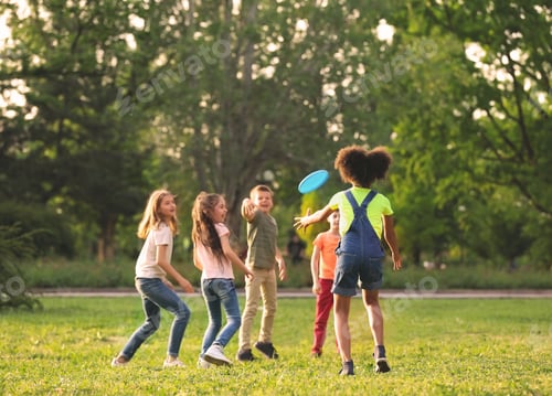 Preview: Cute little children playing with frisbee outdoors on sunny day