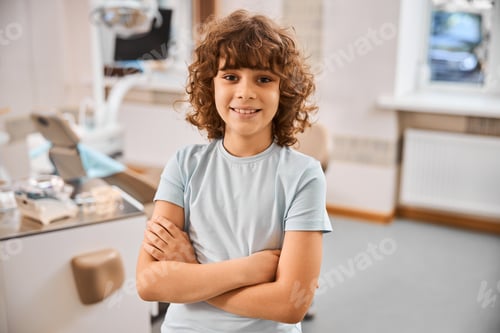 Preview: Smiley kid posing with arms crossed in doctor office