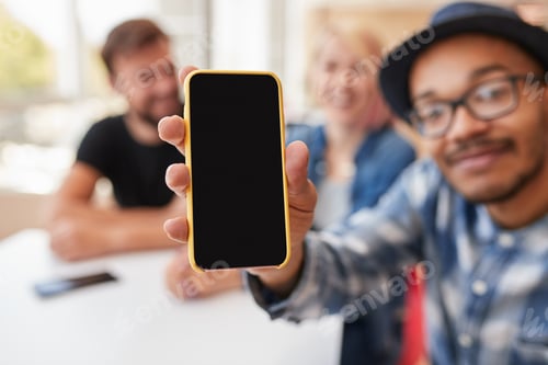 Preview: Man showing smartphone during friends meeting