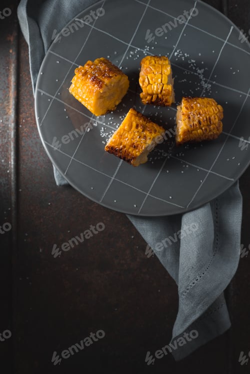 Preview: Slices of roasted corn on ceramic plate