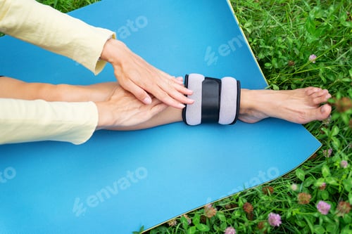 Preview: Ankle Weight Exercise on Yoga Mat Outdoors