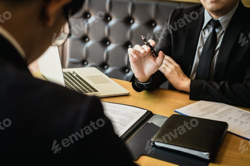 Preview: Male manager holds the pen and is explaining about the new employee work plan.