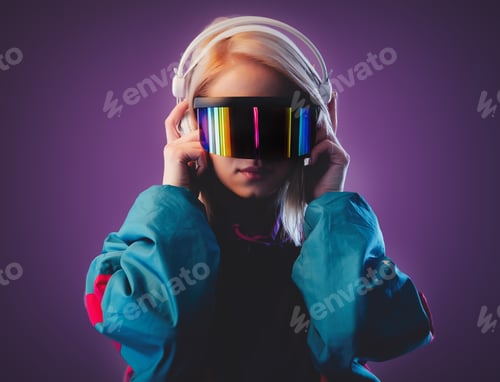 Preview: Blonde in VR glasses and headphones on pink background