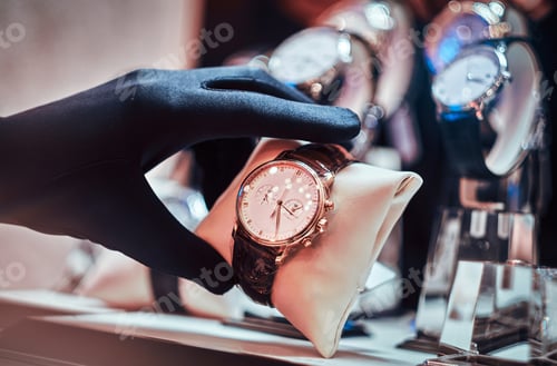 Preview: Close-up of the seller's hand in gloves shows the exclusive men's watch from the new collection