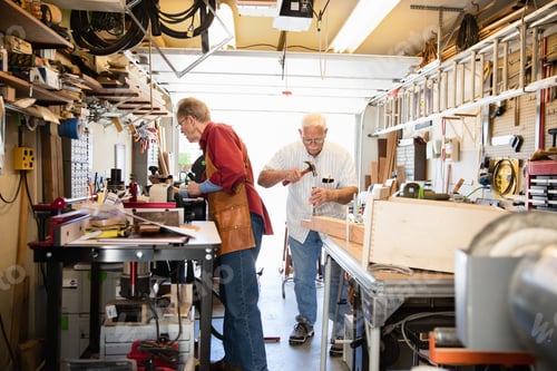 Preview: Senior men working with hammer in carpentry workshop
