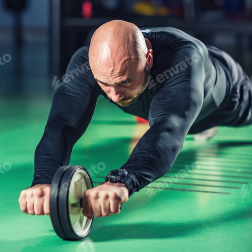 Preview: Man exercising abs on roller in the gym
