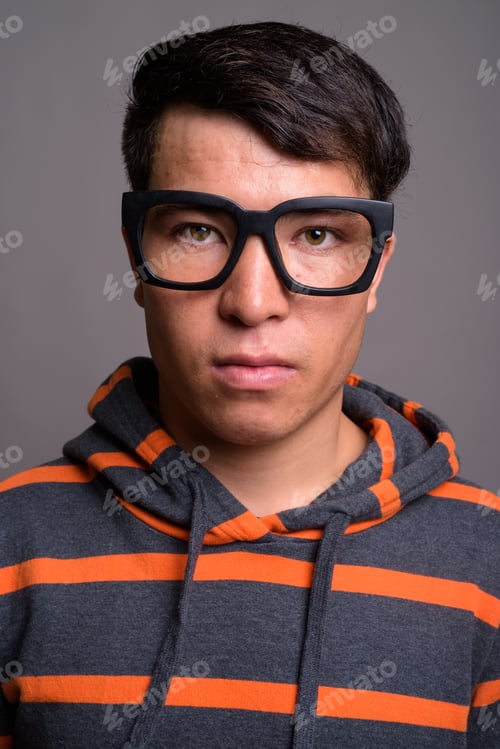 Preview: Young Asian nerd man wearing hoodie against gray background
