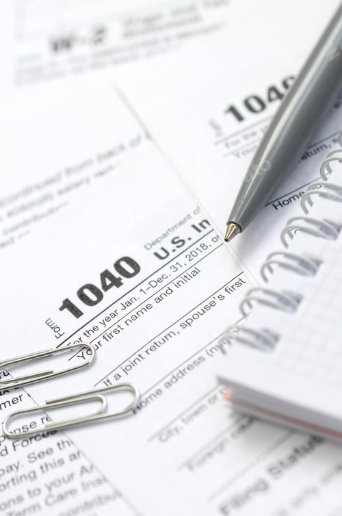 Preview: The pen and notebook is lies on the tax form 1040 U.S. Individual Income Tax Return