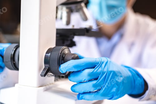 Preview: professional research scientist using microscope in science chemistry laboratory, medical technology