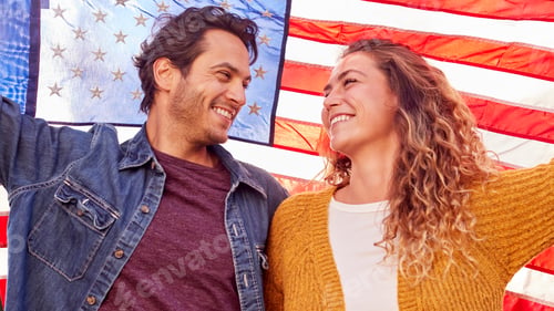Preview: Portrait Of Patriotic American Couple Outdoors Holding Stars And Stripes Flag