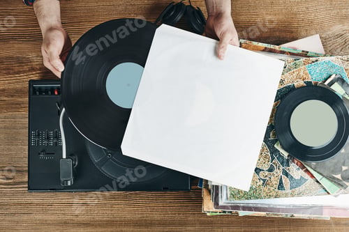 Preview: Man listening to music from vinyl record. Playing music from analog disk on turntable player. Mockup