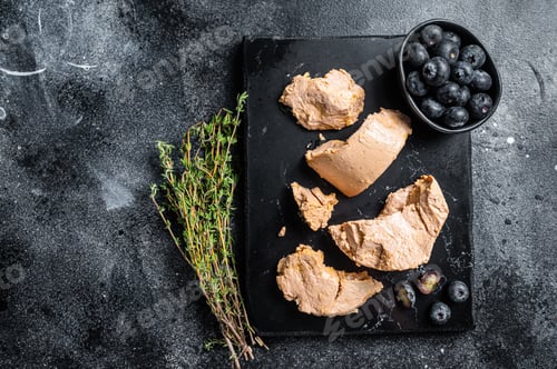 Preview: Foie gras duck liver pate and fresh blueberry. Black background. Top view. Copy space