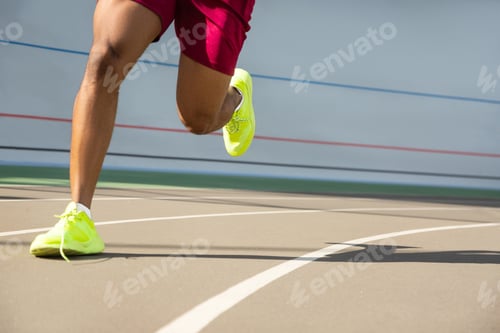 Preview: Fit male athletes legs running at the stadium