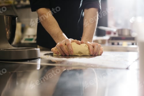 Preview: Close up. The cook kneads the dough with his hands, making macaroons or cakes.