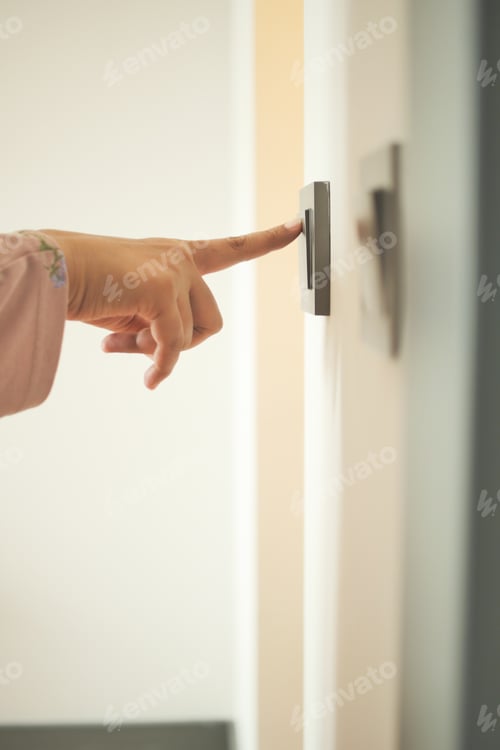 Preview: A finger turning on lighting switch .