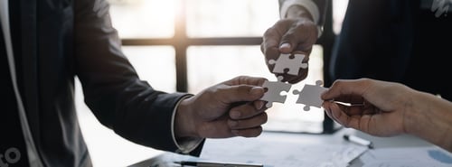 Preview: A group of business people assembling jigsaw puzzle. The concept of cooperation, teamwork, help and