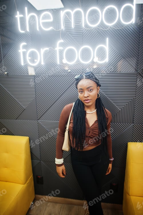 Preview: In the mood for food. African woman in cafe.