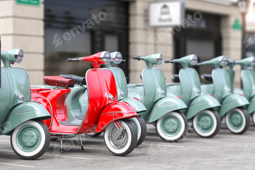 Preview: Vintage moped scooter in row on a parking of the city.