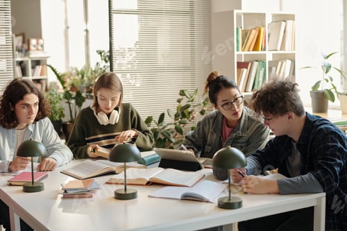 Preview: Group of College Students Collaborating Studying at Desk in Class