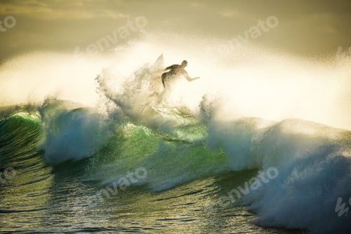 Preview: A surfer riding high on a green wave