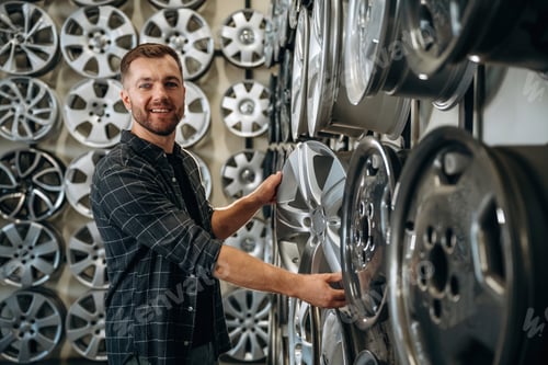 Preview: Choosing the right disk. Man worker is maintenance station with tires, wheels