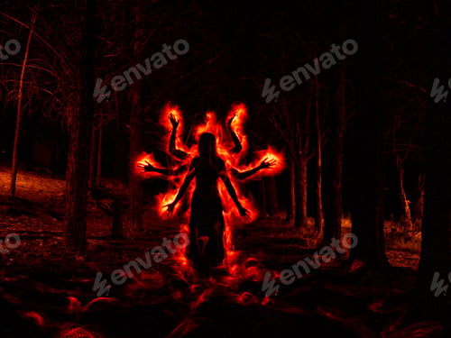 Preview: Image of woman in the dark forest silhouetted with red fire effect on the sides