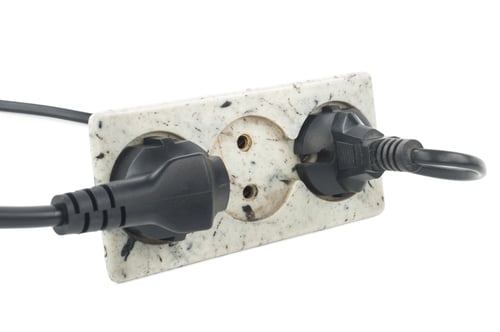 Preview: Triple electrical socket on white wall with two plugged cables