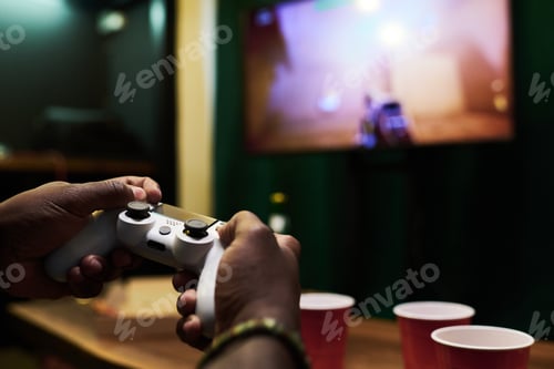Preview: Hands of young African American man pressing buttons on controller