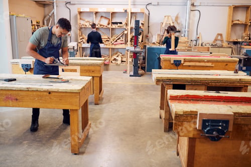 Preview: Wide Angle View Of Carpentry Workshop With Students Studying For Apprenticeship At College