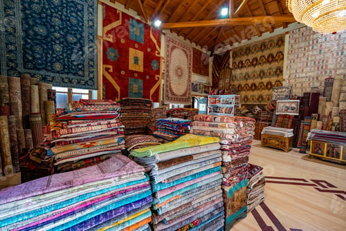 Preview: Large stacks of oriental rugs in a store. Colorful carpet market. Turkey