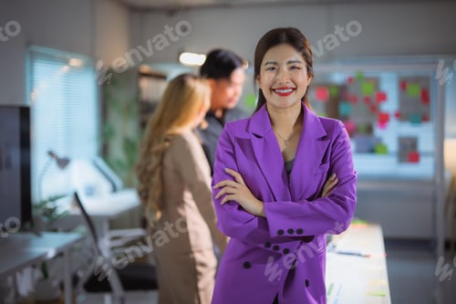 Preview: Asian businesswoman standing confidently in modern startup office environment
