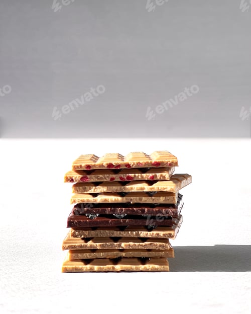 Preview: Chocolate products of different types on a colored background close-up with a place for text