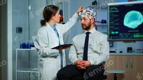 Preview: Man sitting on neurological chair with brainwave scanning headset
