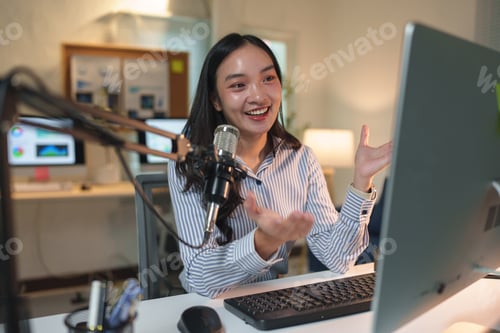 Preview: Young asian businesswoman recording a podcast with a professional microphone in a modern office, eng