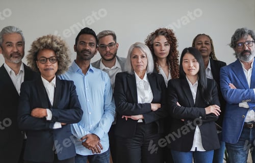 Preview: Group of multi generational business people looking serious on camera inside coworking office