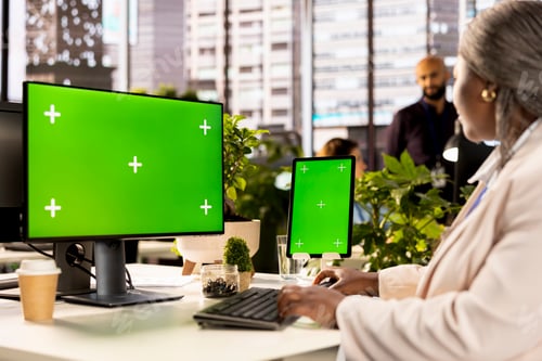 Preview: Female employee completing business operations and tasks next to chroma key