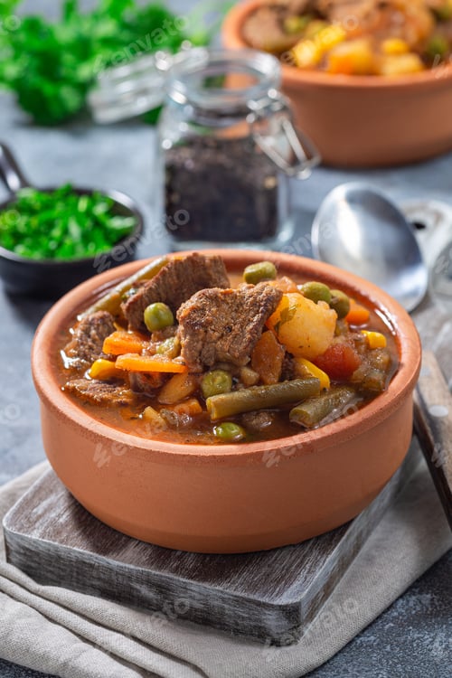 Preview: Vegetable beef stew with potato, green beans, carrot, peas and corn, in ceramic bowl, vertical
