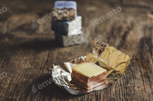 Preview: Sweets In Unfolded Wrapper (On A Wooden Surface)