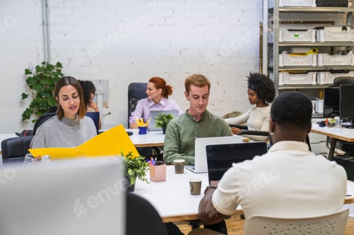 Preview: Young professionals collaborating in modern coworking space