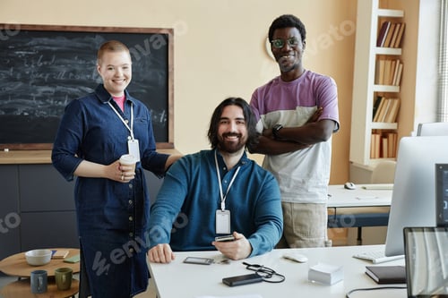Preview: Group of young smiling intercultural office managers looking at camera