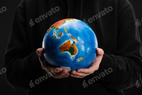 Preview: Cropped view of globe in female hands isolated on black, global warming concept