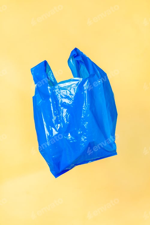 Preview: Blue plastic bag floating with a yellow wall