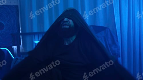 Preview: Man is getting emotional in neon room. Media. Man vividly shows aggressive emotions alone at home