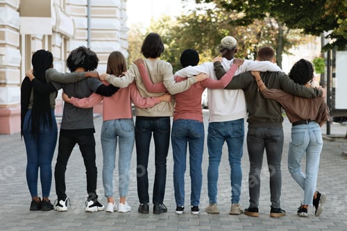 Preview: Back view of people hugging while standing on the street