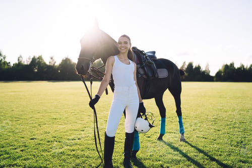 Preview: Positive female equestrian with horse at ranch