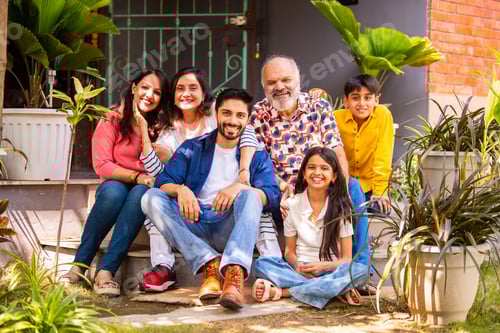 Preview: Indian family enjoying outdoor bonding time on steps during weekend relaxation
