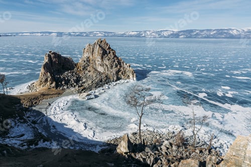 Preview: view of rock formations on lake shore over water and hills on background, Russia, Lake Baikal